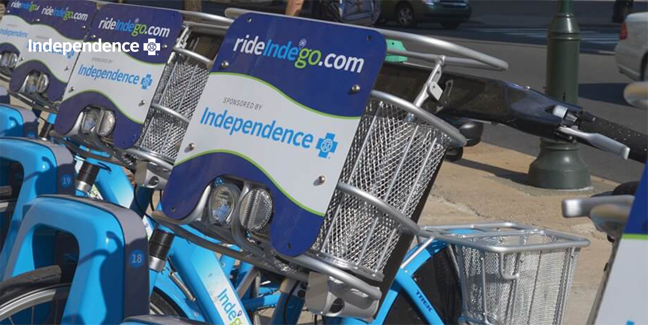 Close up of Indego bike handles with rideindego.com signage on basket