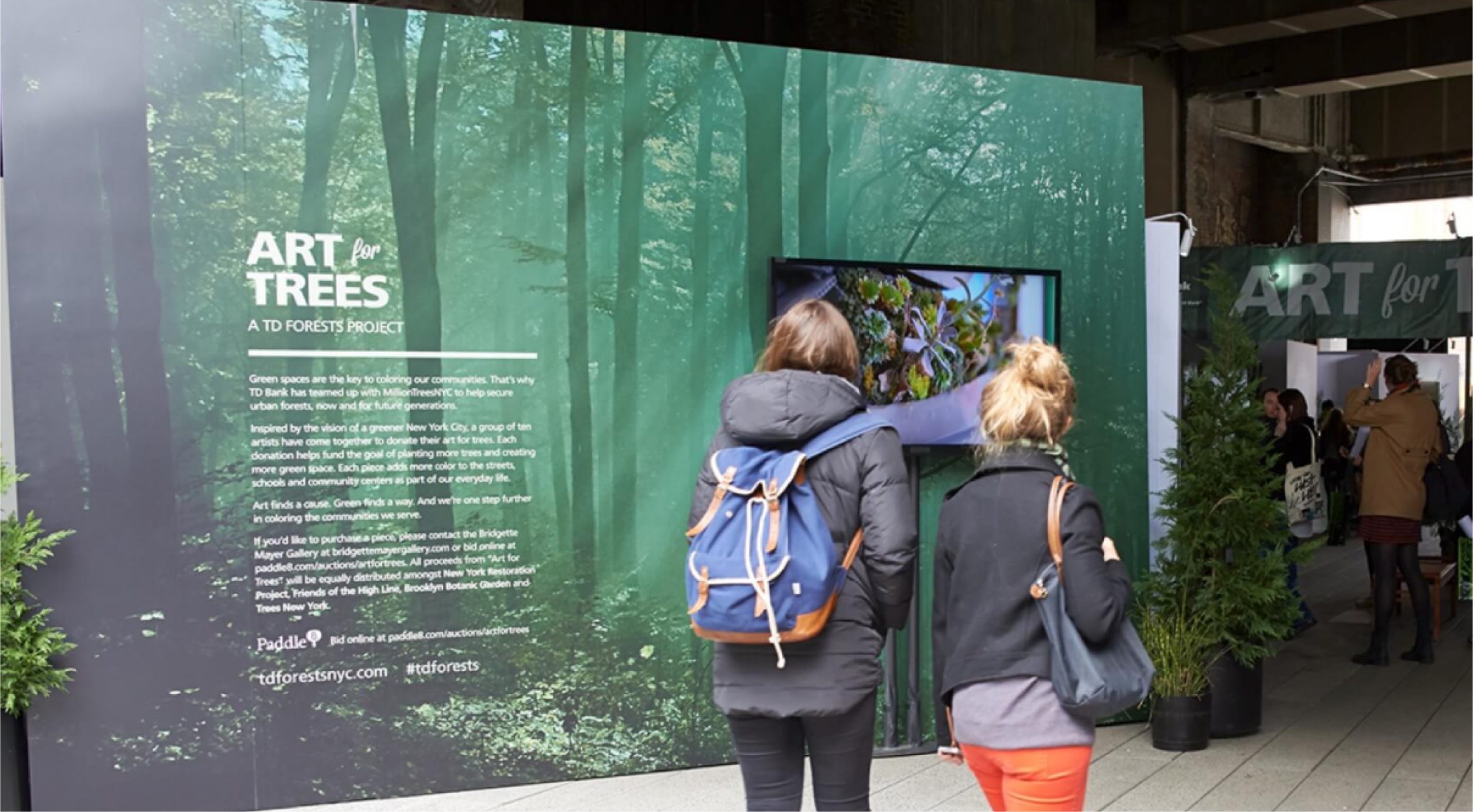 Image of two woman walking into the TD Bank Art for Trees experience in New York City